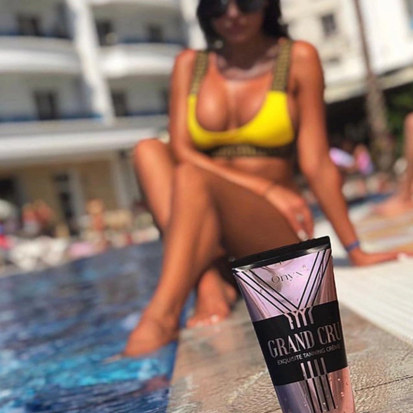 Onyx Grand Cru Lotion vor Frau am Pool – perfekte Sonnenpflege für gleichmäßige Bräune auf der Sonnenliege
