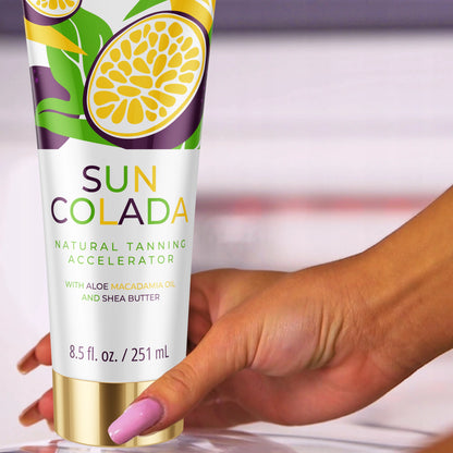 Hand holding Onyx Suncolada tanning lotion with white and gold packaging, infused with shea butter and macadamia oil for ultra moisturizing tan accelerator